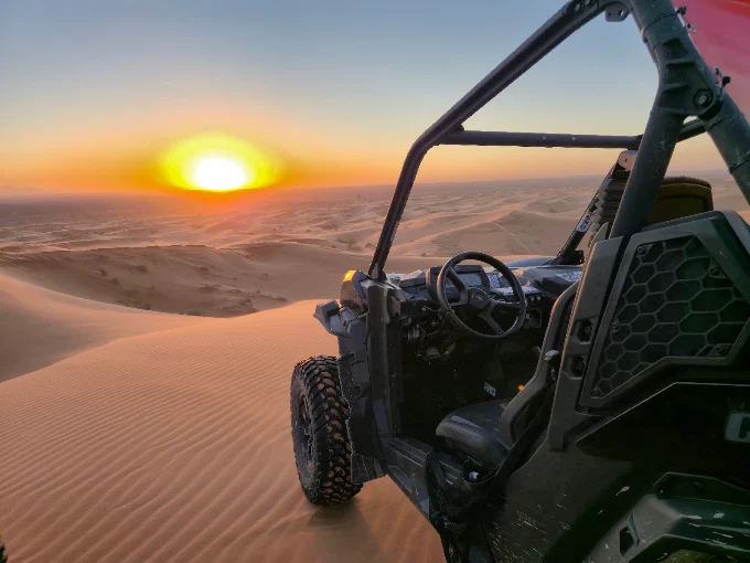 A creator filming the desert at sunset